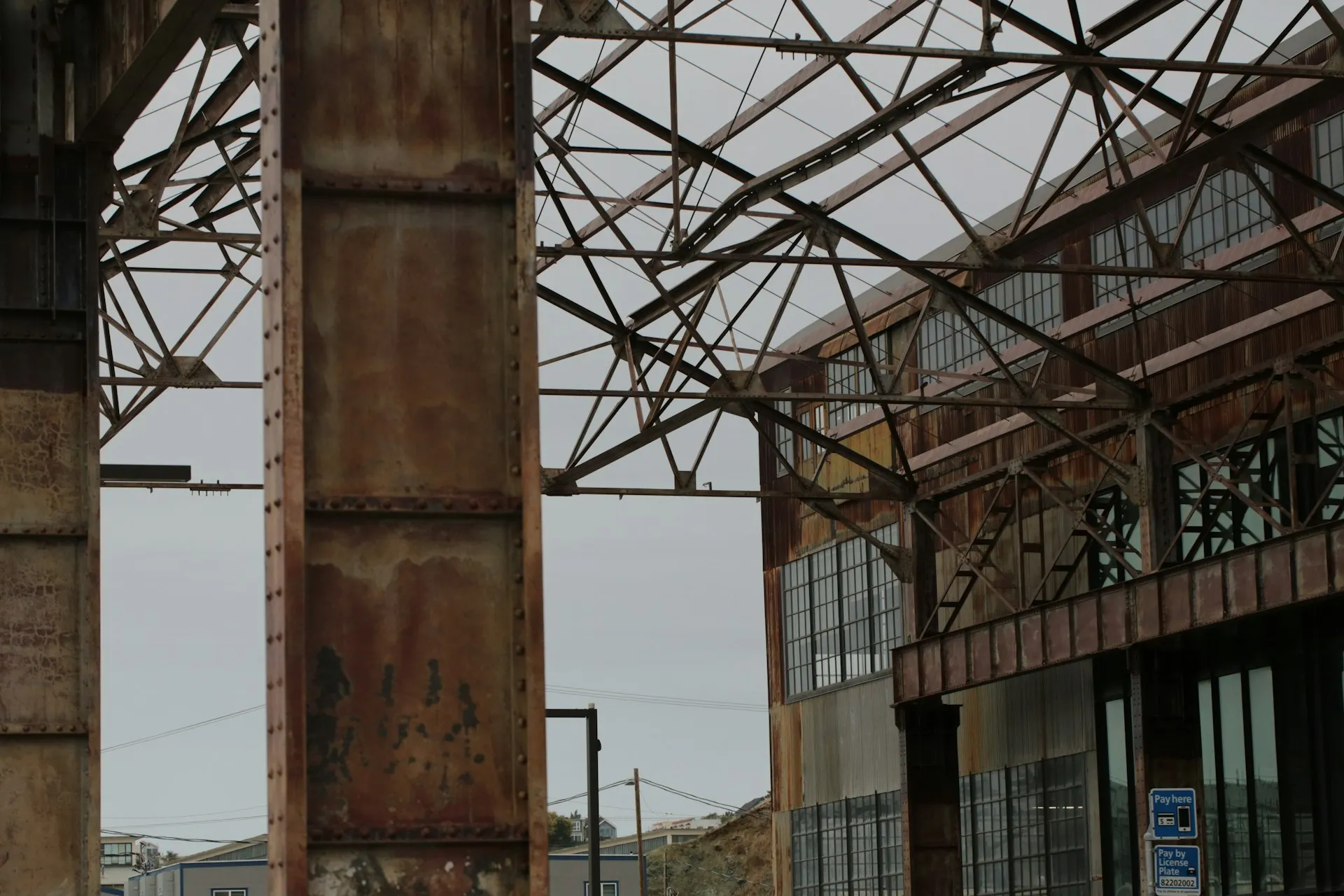 Rusty steel columns and roof trusses in an old industrial building