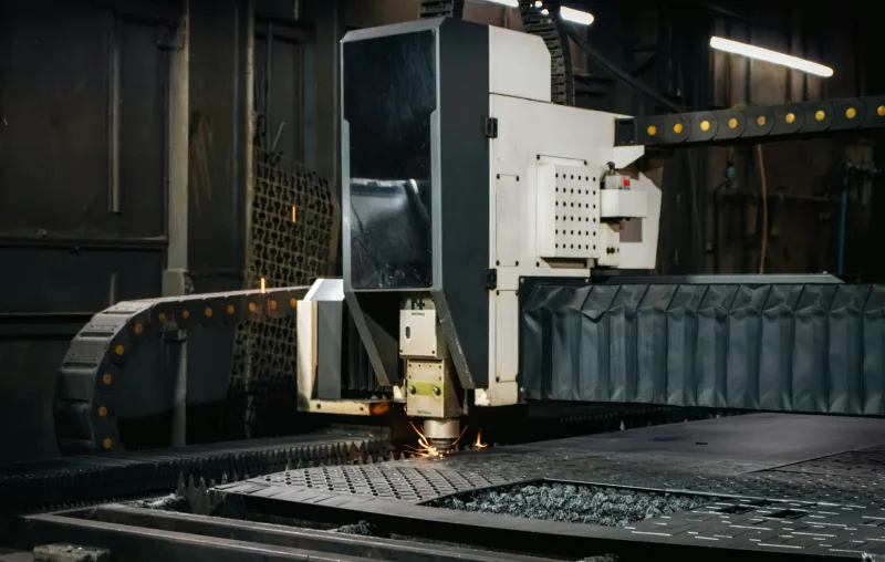 CNC cutting machine cutting a steel plate in a fabrication workshop