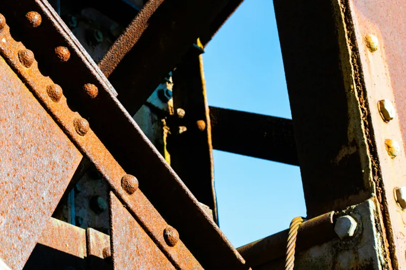 Close-up of weathered steel members joined with rivets