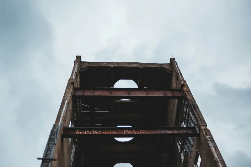Steel frame seen from below against a cloudy sky