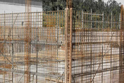 Steel reinforcement mesh cages standing ready before a concrete pour